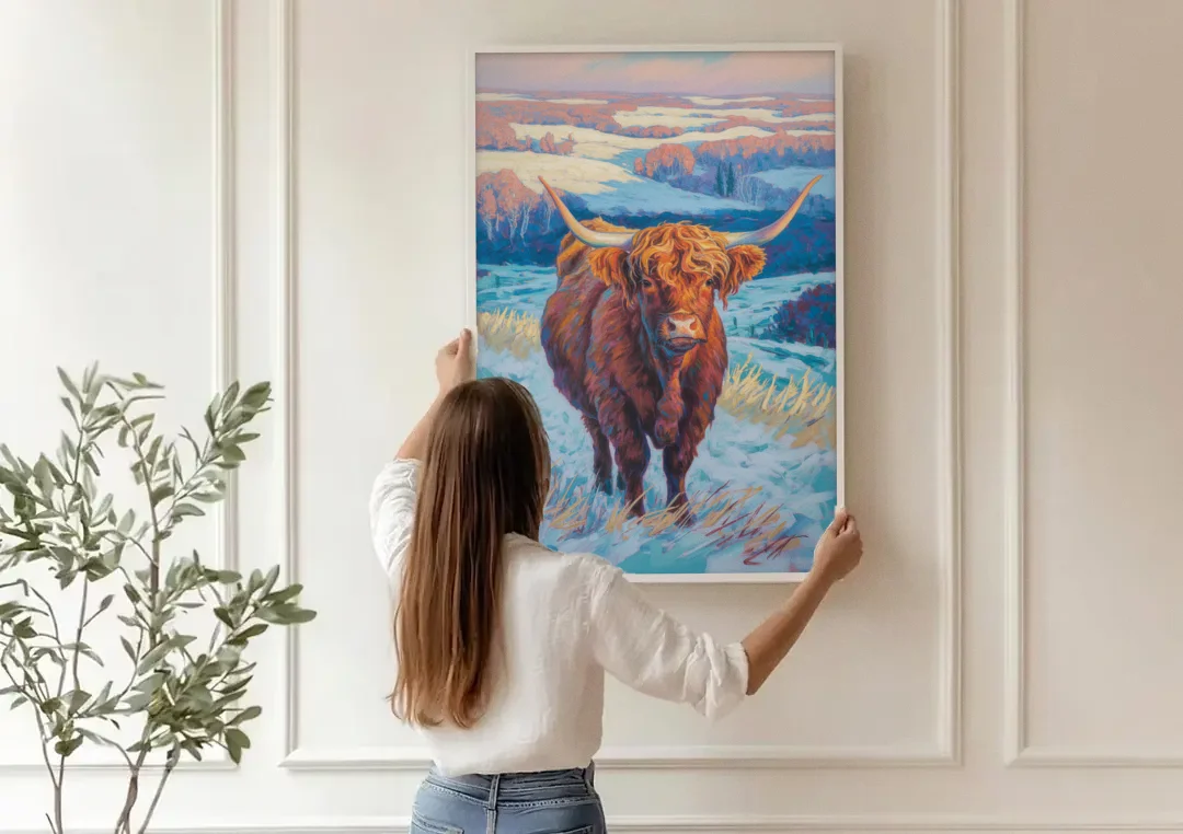 Winter Wonderland Highland Cow canvas wall art being hung on a paneled wall
