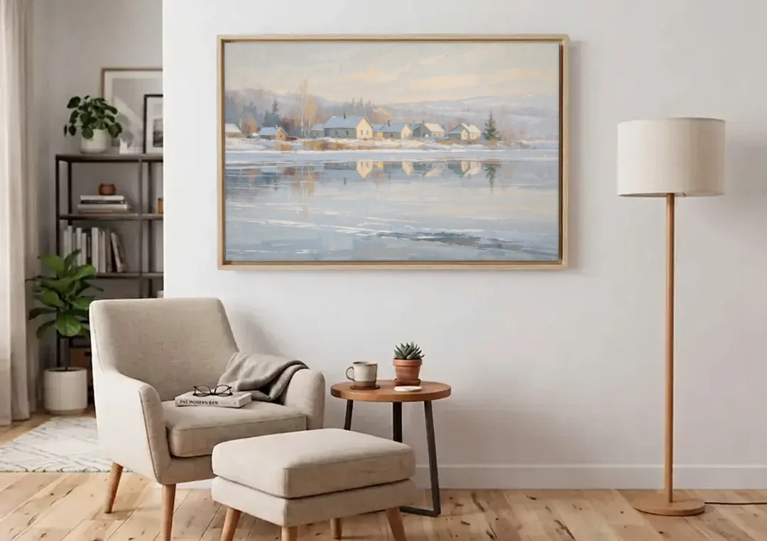 Winter Wonderland Wall Art by the Frozen Lake canvas wall art above an armchair in a bright living room