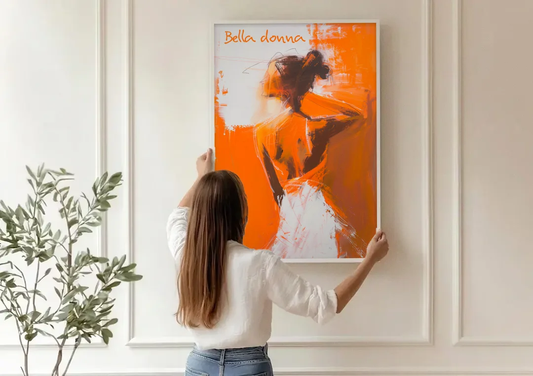 Woman Painting in Bold Orange Strokes canvas wall art being hung on a paneled wall