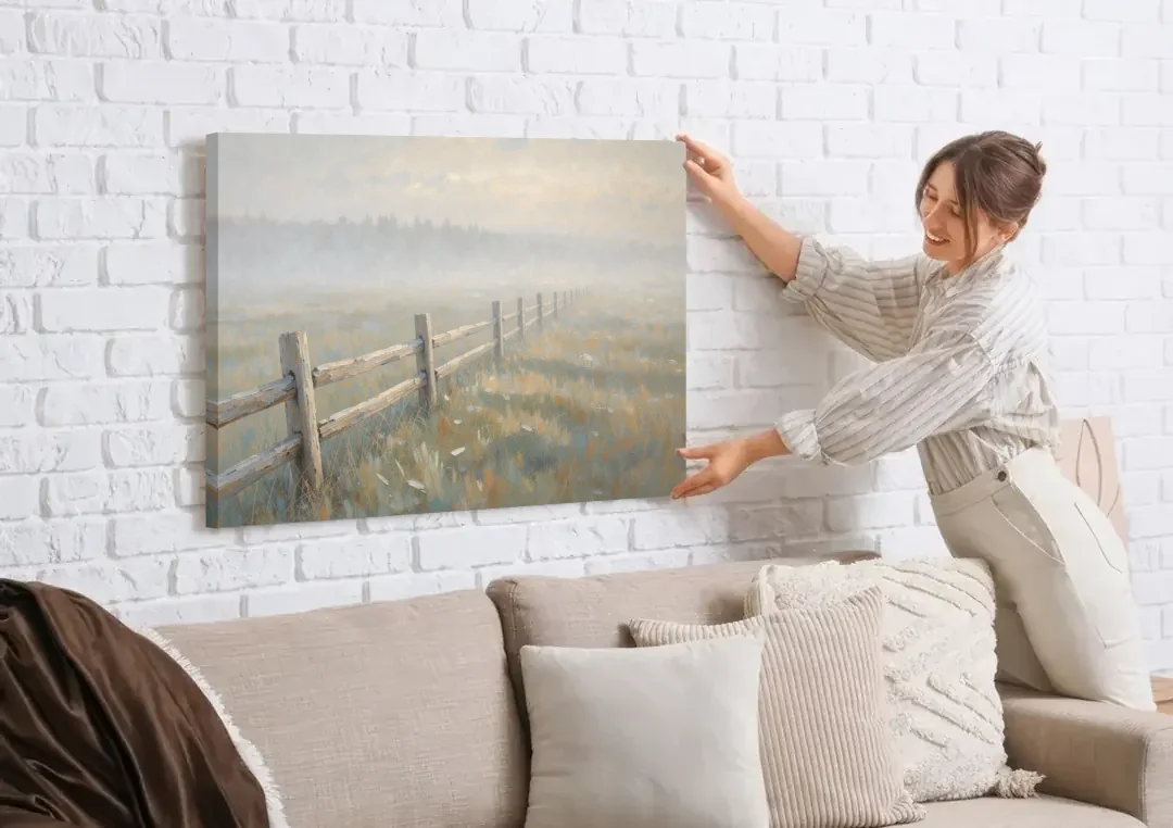 Wooden Fence Painting Through the Morning Mist canvas wall art being hung on a white brick wall above a sofa