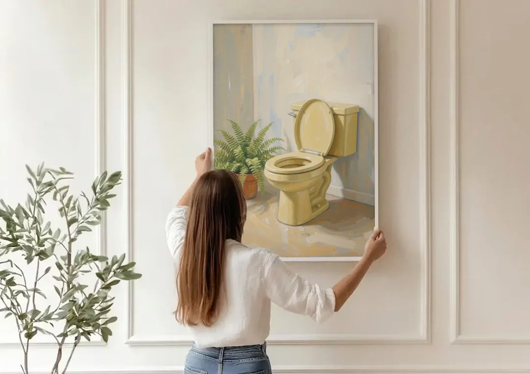 Yellow Bathroom Wall Art with a Potted Fern canvas wall art being hung on a paneled wall