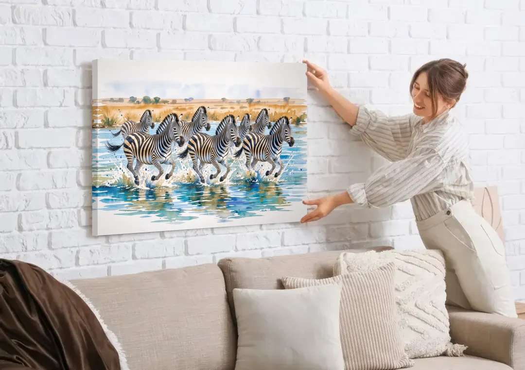Zebra Watercolor Painting River Crossing canvas wall art being hung on a white brick wall above a sofa
